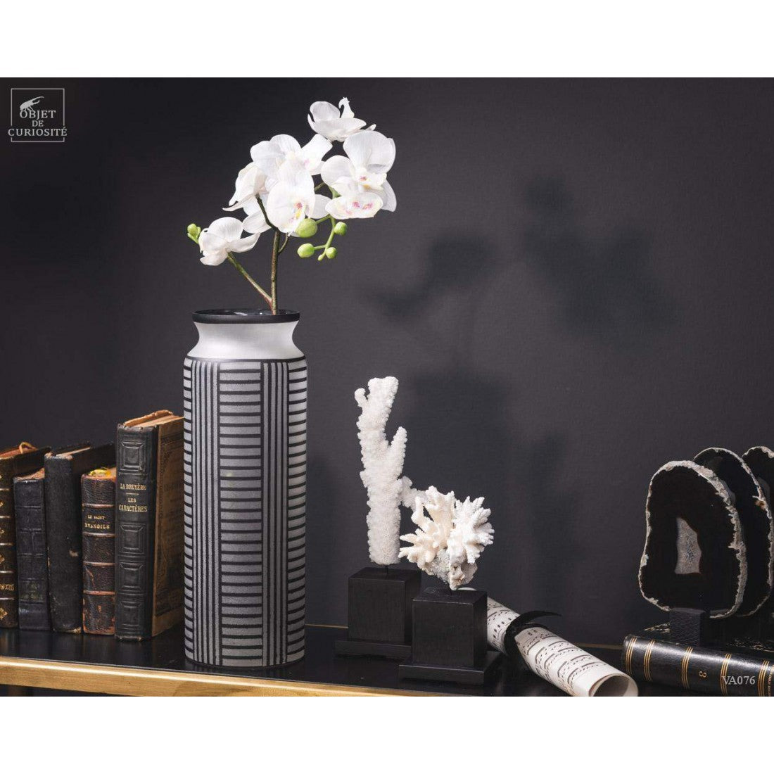 Black lines on a white frosted vase