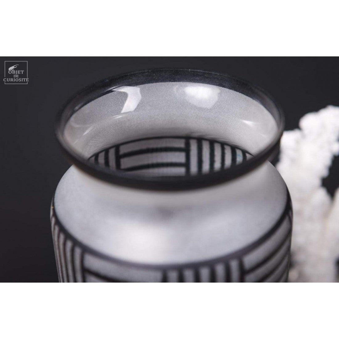 Black lines on a white frosted vase