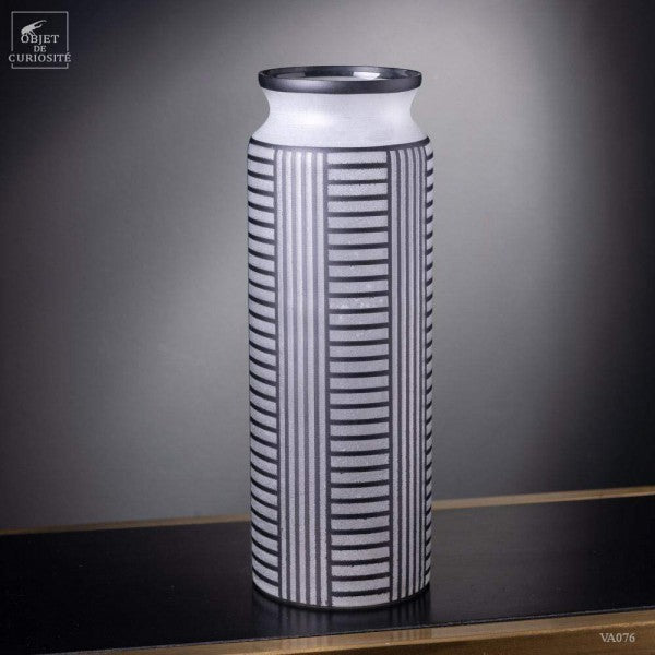 Black lines on a white frosted vase